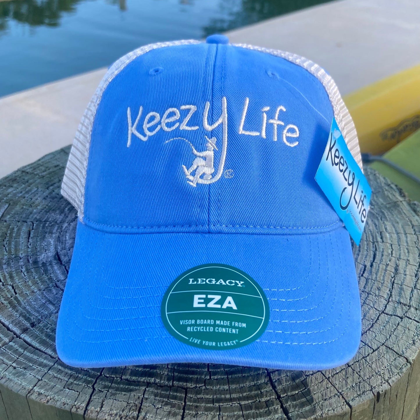 Powder Blue trucker cap says Keezy Life. The letter Y has a boy fishing on the bottom of the Y.